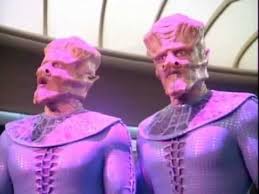 Two of the aliens in the purple light that keeps them in place on the bridge.