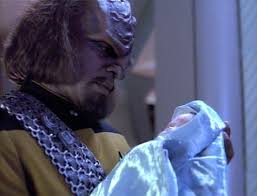 Worf hold's Keiko's baby after delivery.