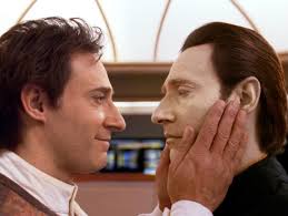 A very young Dr. Soong clutches Data's face