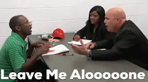 A man sits across from another man and a woman. The text reads "leave me alooooone."