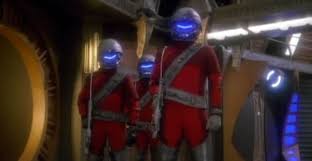 Three hunters in red suits and helmets.