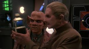 Odo and Quark staring at the baby changeling