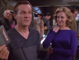 Happy Sloan with his wife, holding a padd