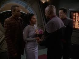Ross presides, Yates and Sisko hold hands, and Jake is best man