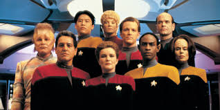 Neelix, Kim, Kes, Paris, EMH (back row). Chakotay, Janeway, Tuvok, Torres (front row)
