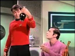 Scotty holds up a bottle of liquid