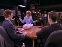 Dana standing in front of Casey and Dan as the turkey falls on the desk