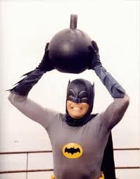 Adam West's Batman holding a bomb