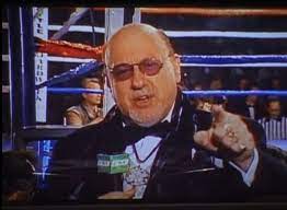 The cut man on the screen in front of the boxing ring