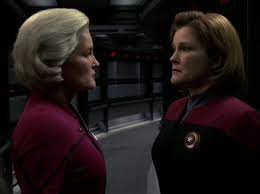Admiral Janeway (left) looks at Captain Janeway (right)